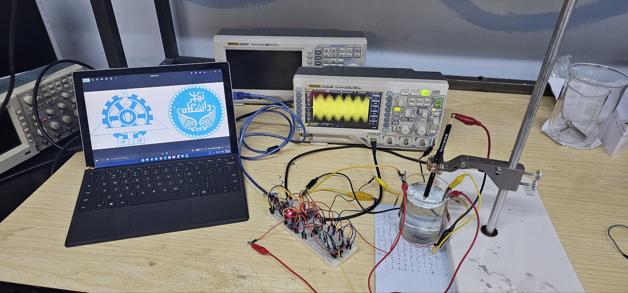 Bench test: saline phantom, probe, oscilloscope showing the 10 Hz beat